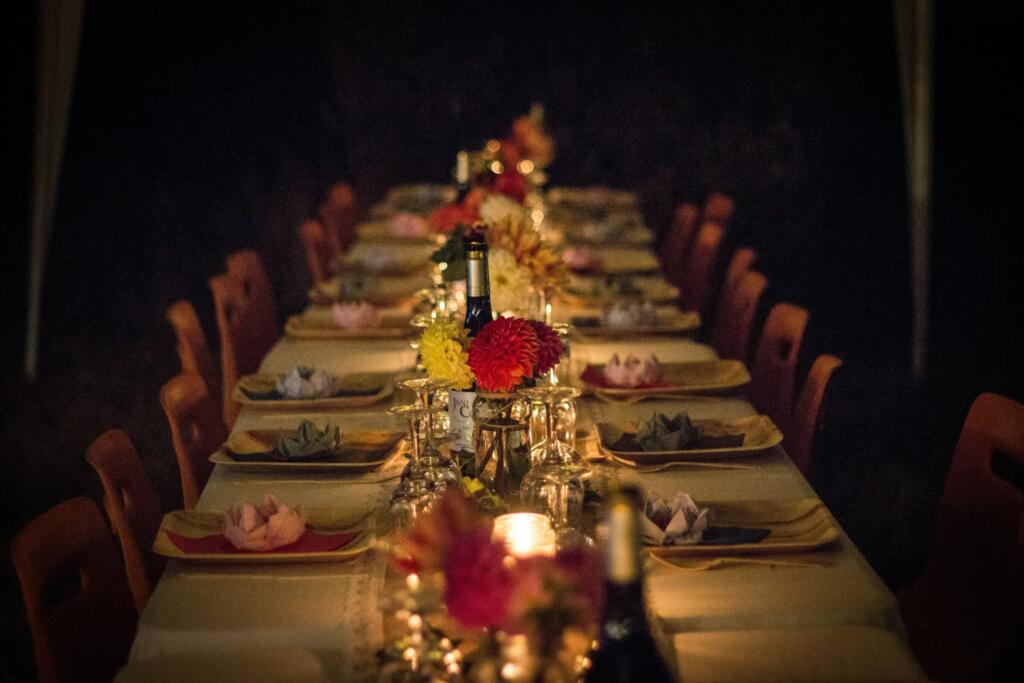 Long dining table set with flowers and candles for a celebration