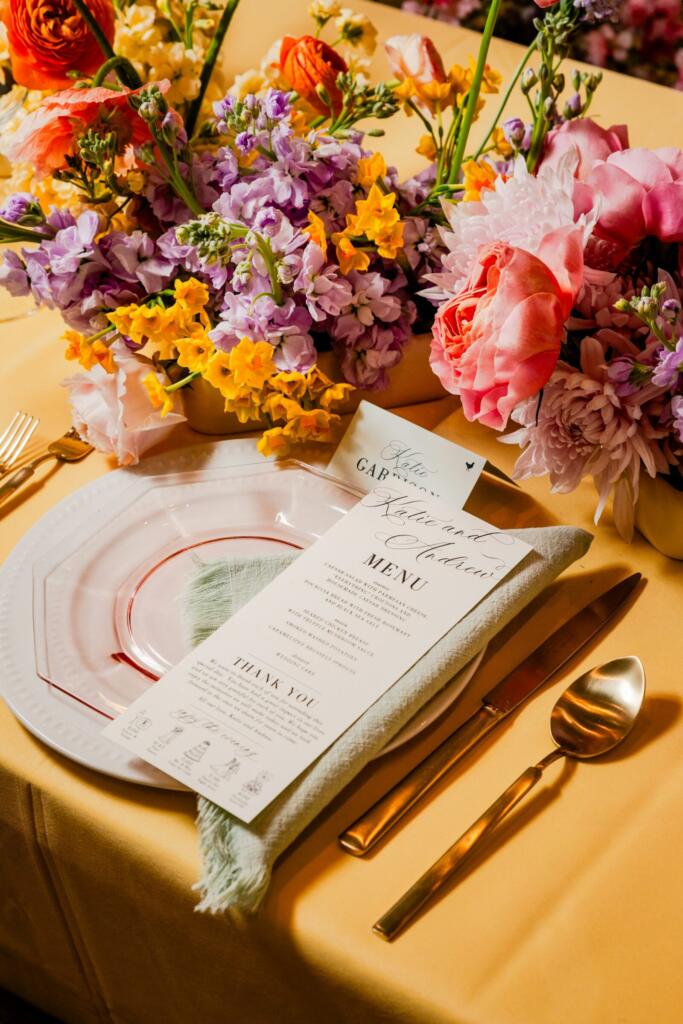 Wedding place setting with a menu card and flowers